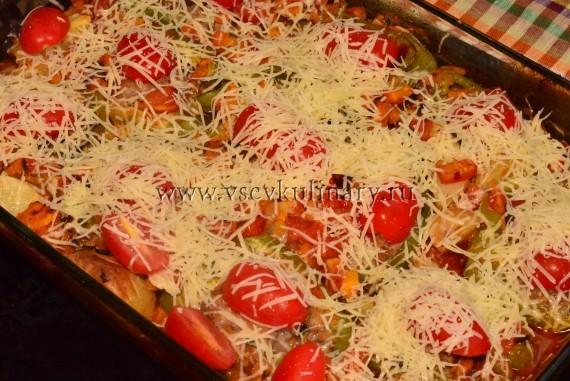 За несколько минут до готовности достаньте перцы, положите сверху помидоры и посыпьте тертым сыром, вкуснее пармезаном.